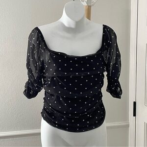Anthropologie Shirred Mesh‎ Top with a black and white polka dot pattern